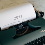 green and black typewriter on brown wooden table