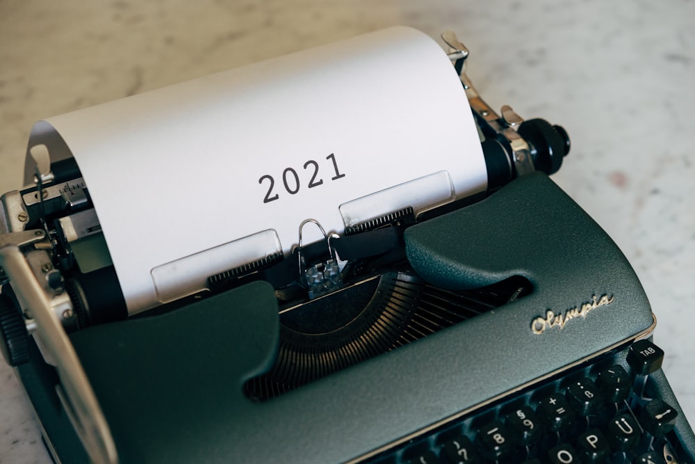 green and black typewriter on brown wooden table