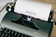 black and white typewriter on green textile