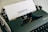 white printer paper on green typewriter