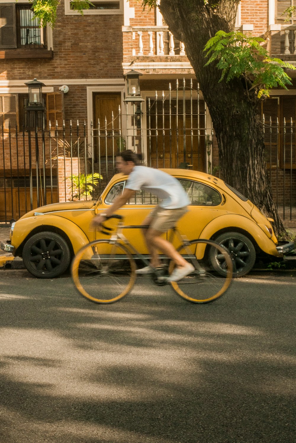 man in white t-shirt riding yellow motorcycle