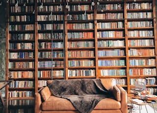 brown wooden book shelves with books
