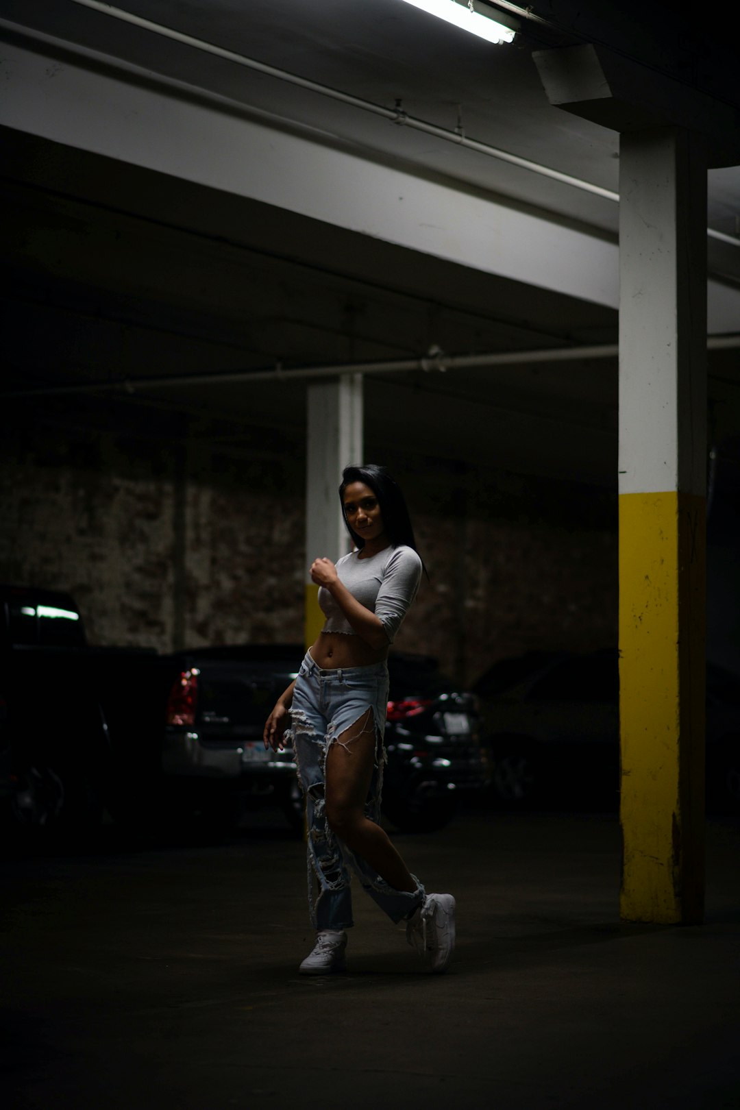 man in white t-shirt and blue denim jeans running on road