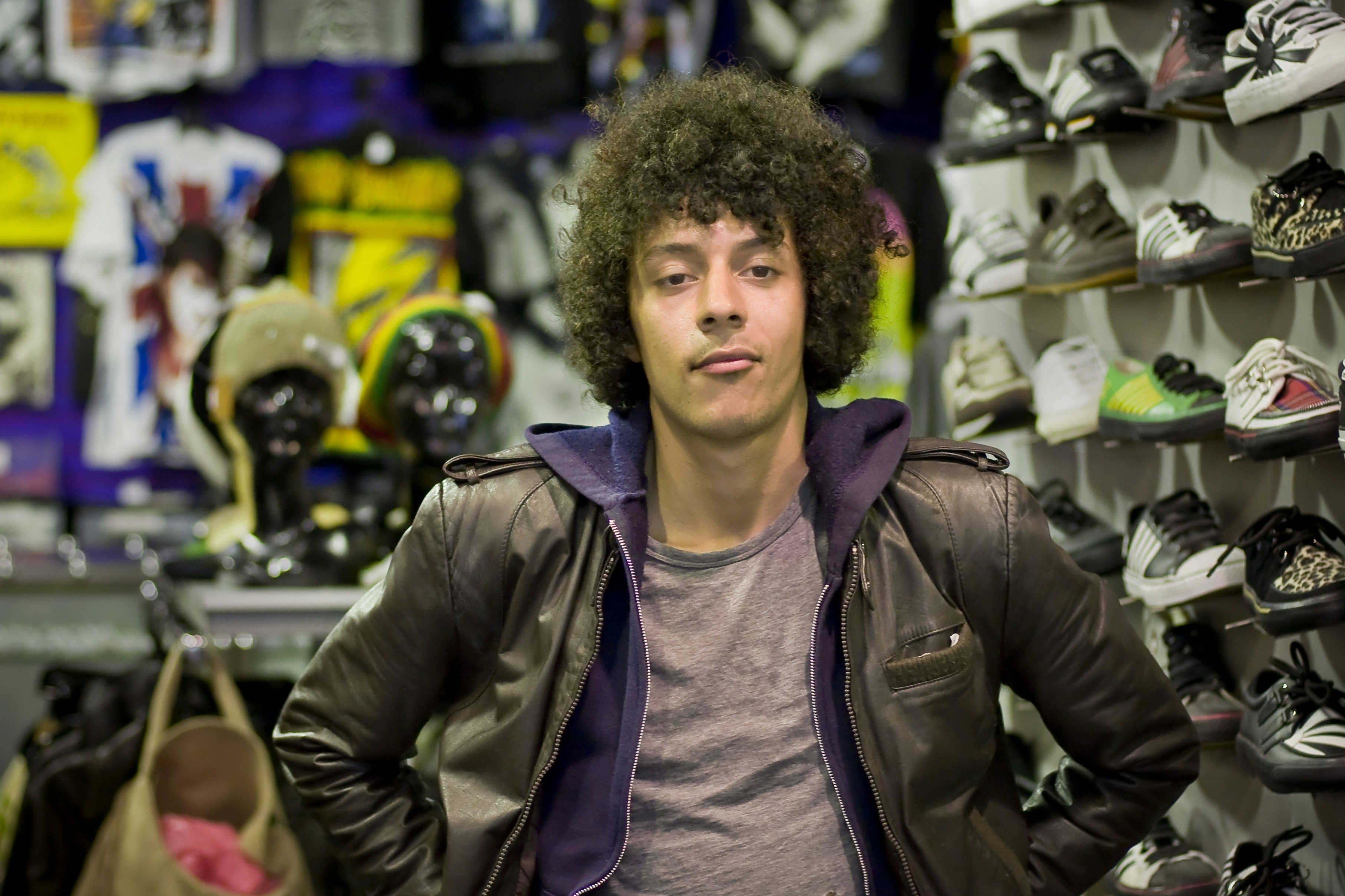 Footwear shop owner in front of a shoe display
