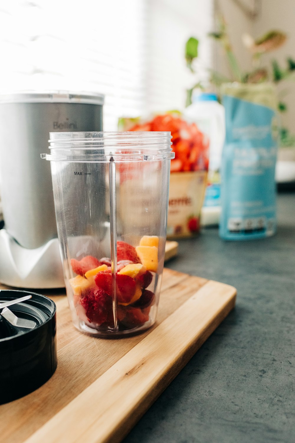clear plastic cup with red and orange fruits