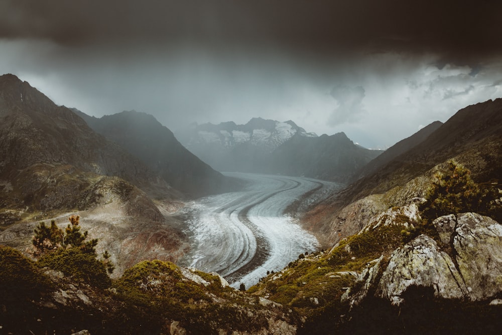 river between mountains during daytime