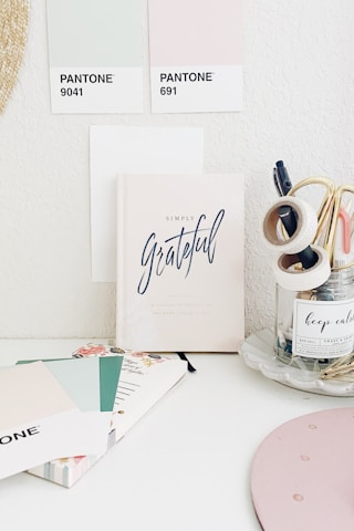 A serene workspace with beige tones and vintage pink accents, symbolizing calm creativity.