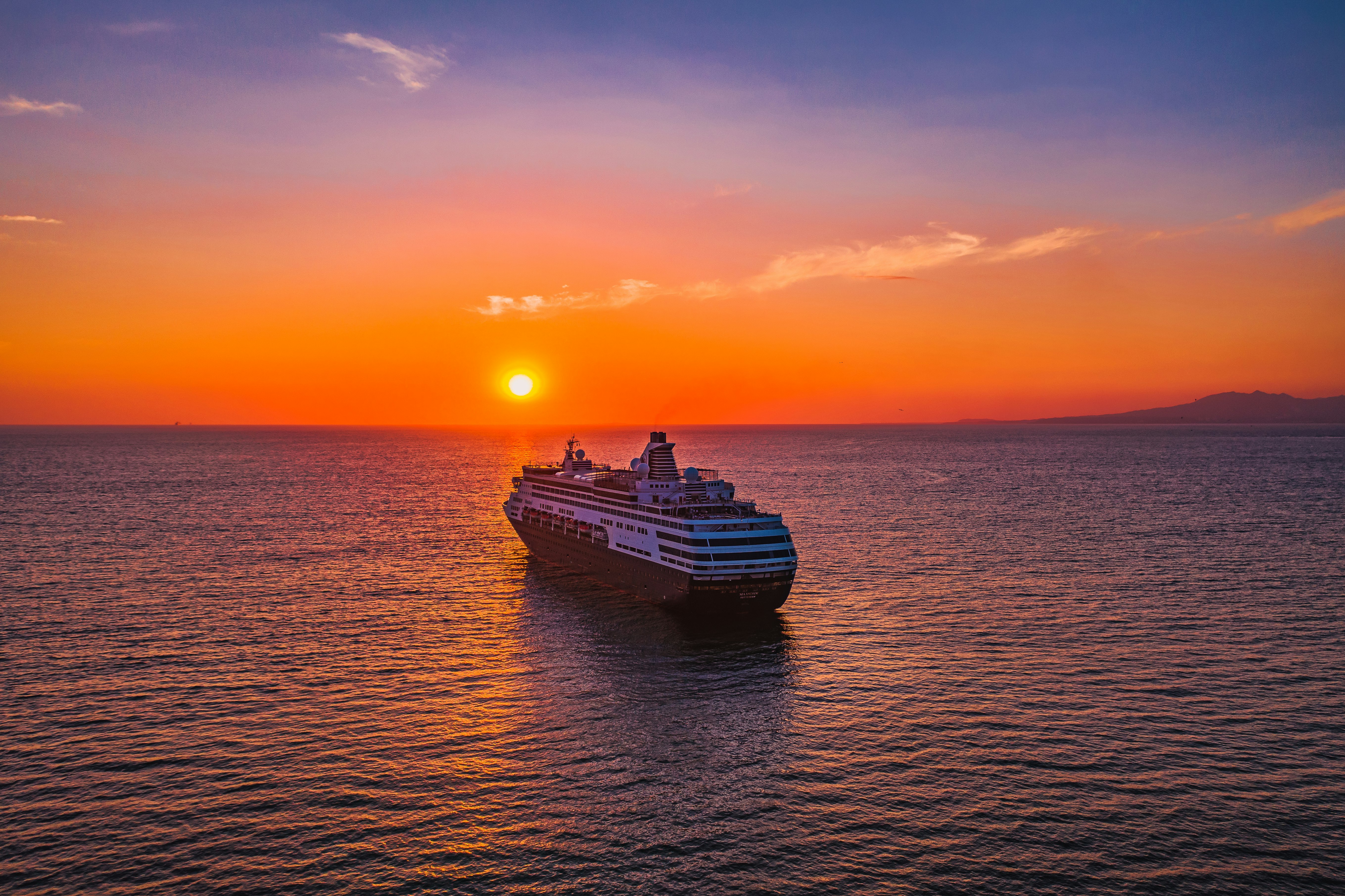 white and black ship on sea during sunset