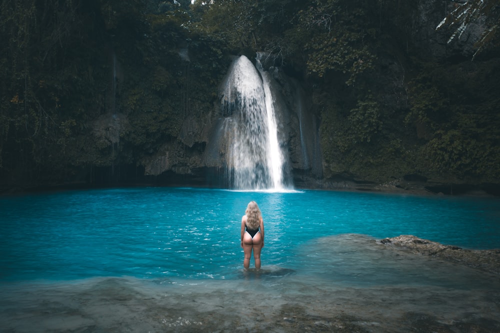 woman in blue bikini swimming on water