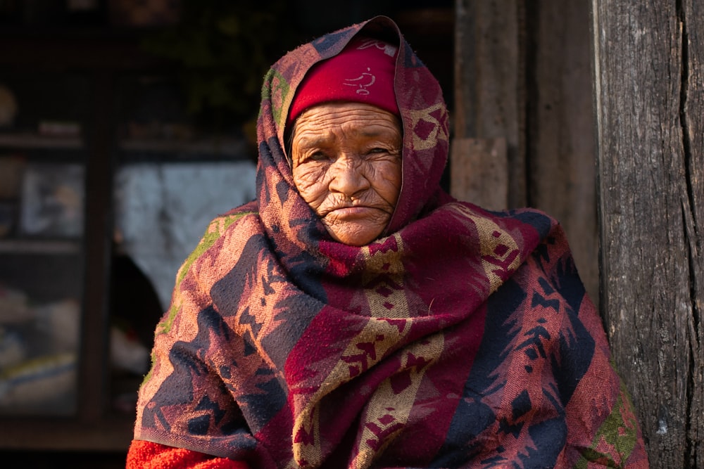 woman in red and brown hijab