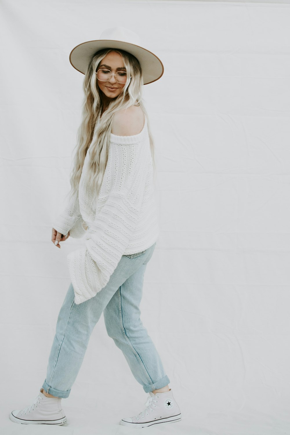 woman in white tank top and blue denim jeans