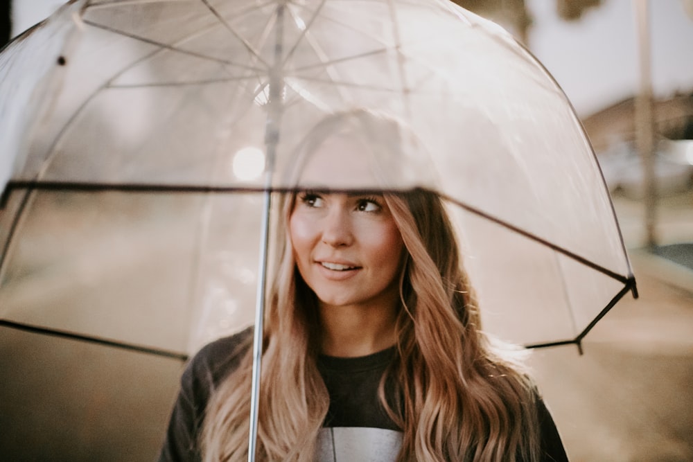 woman in black jacket holding umbrella