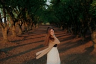 A happy customer twirling in a flowy skirt, with sunlight filtering through trees in a park.