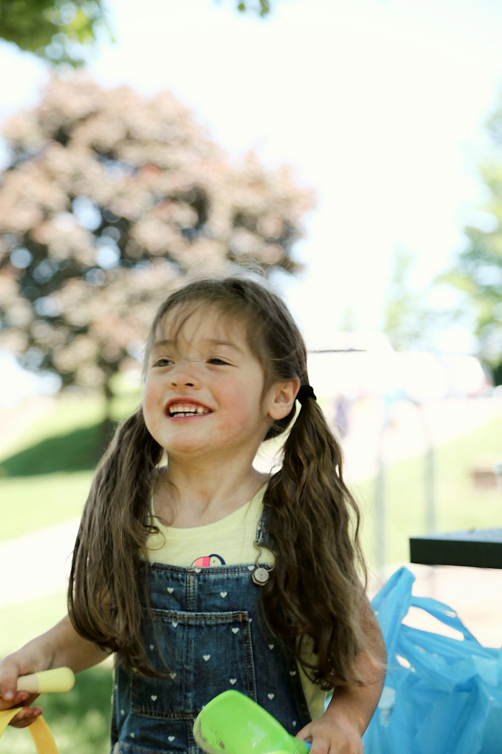 girl in white and blue floral shirt smiling