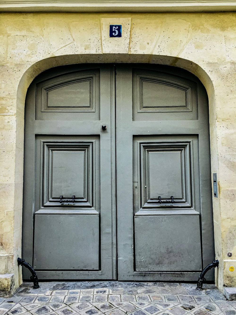 blue wooden door on brown concrete wall