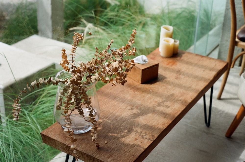 white flowers in clear glass vase on brown wooden table