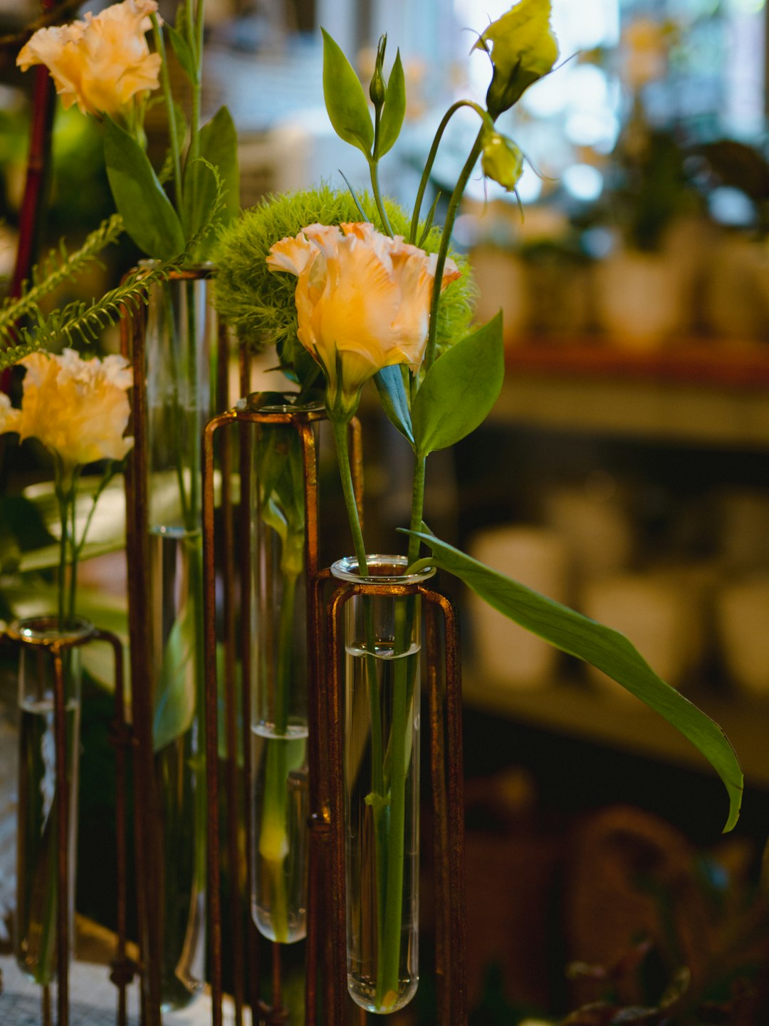 yellow roses in glass bottle