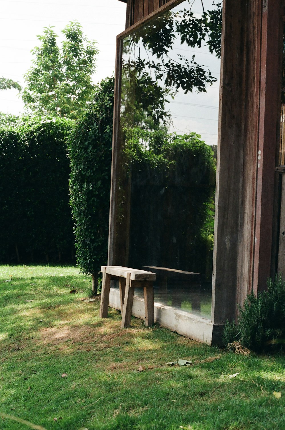 brown wooden table near green grass and trees during daytime