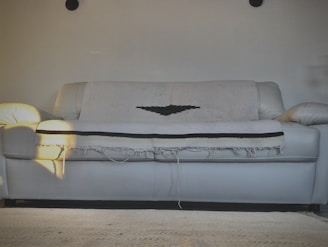 a white couch with a bat on it