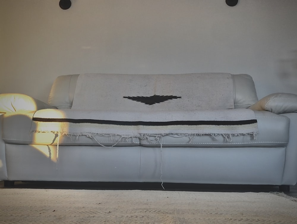 a white couch with a bat on it