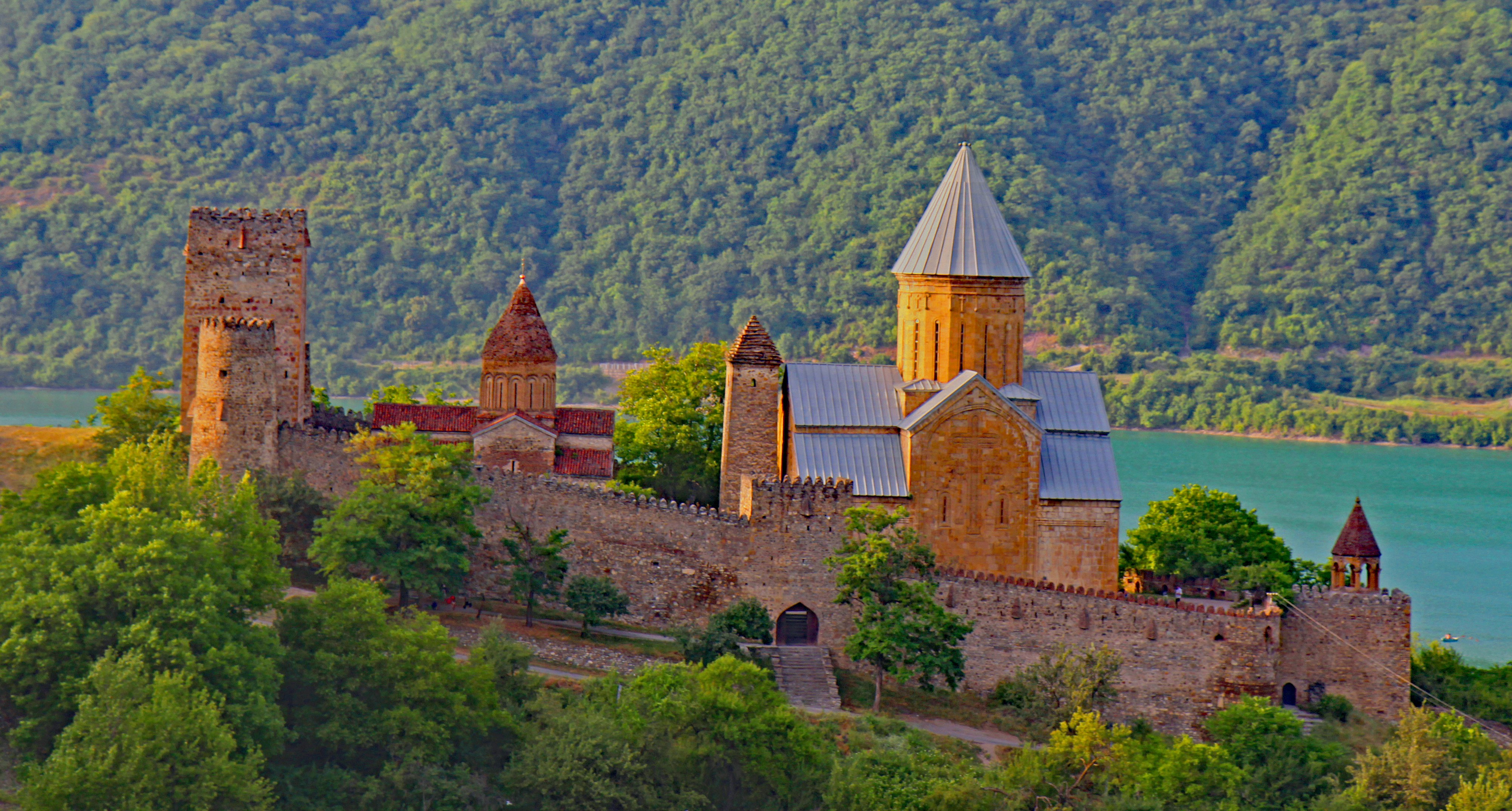 brown concrete building on green grass field during daytime