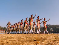 A team of workers dressed in matching uniforms walking confidently outdoors.