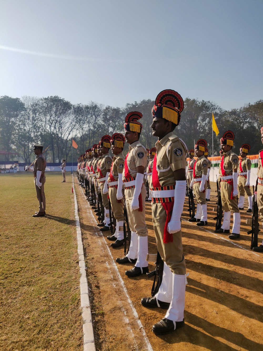 people in white uniform standing on green grass field during daytime