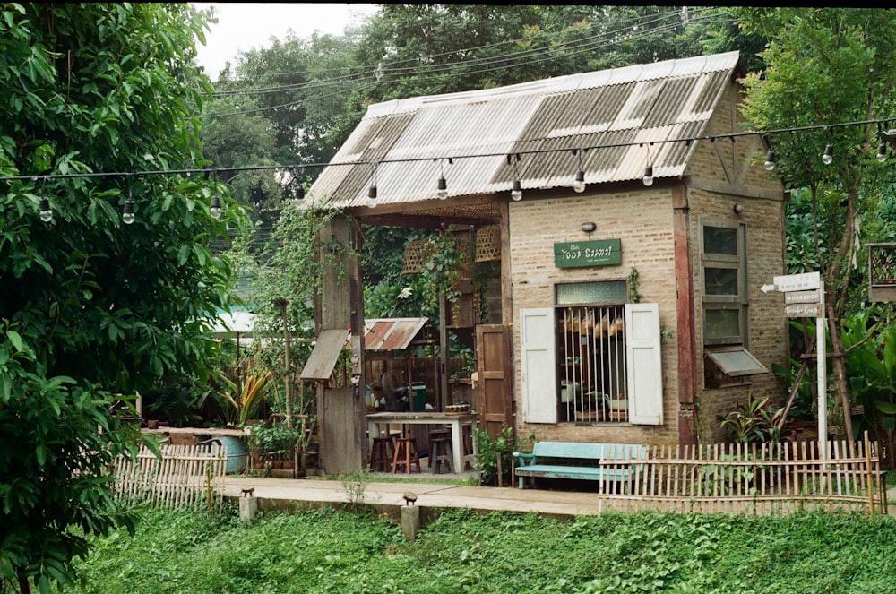 brown wooden house surrounded by green trees during daytime