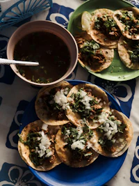 Birria tacos with consomé for dipping