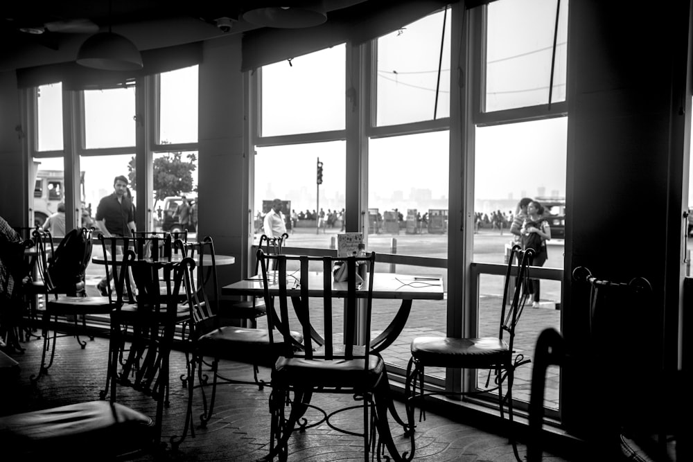 silhouette of people sitting on chairs near window