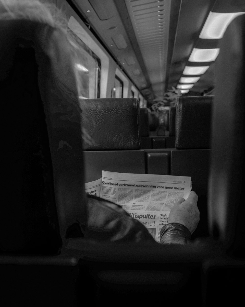 grayscale photo of newspaper on table