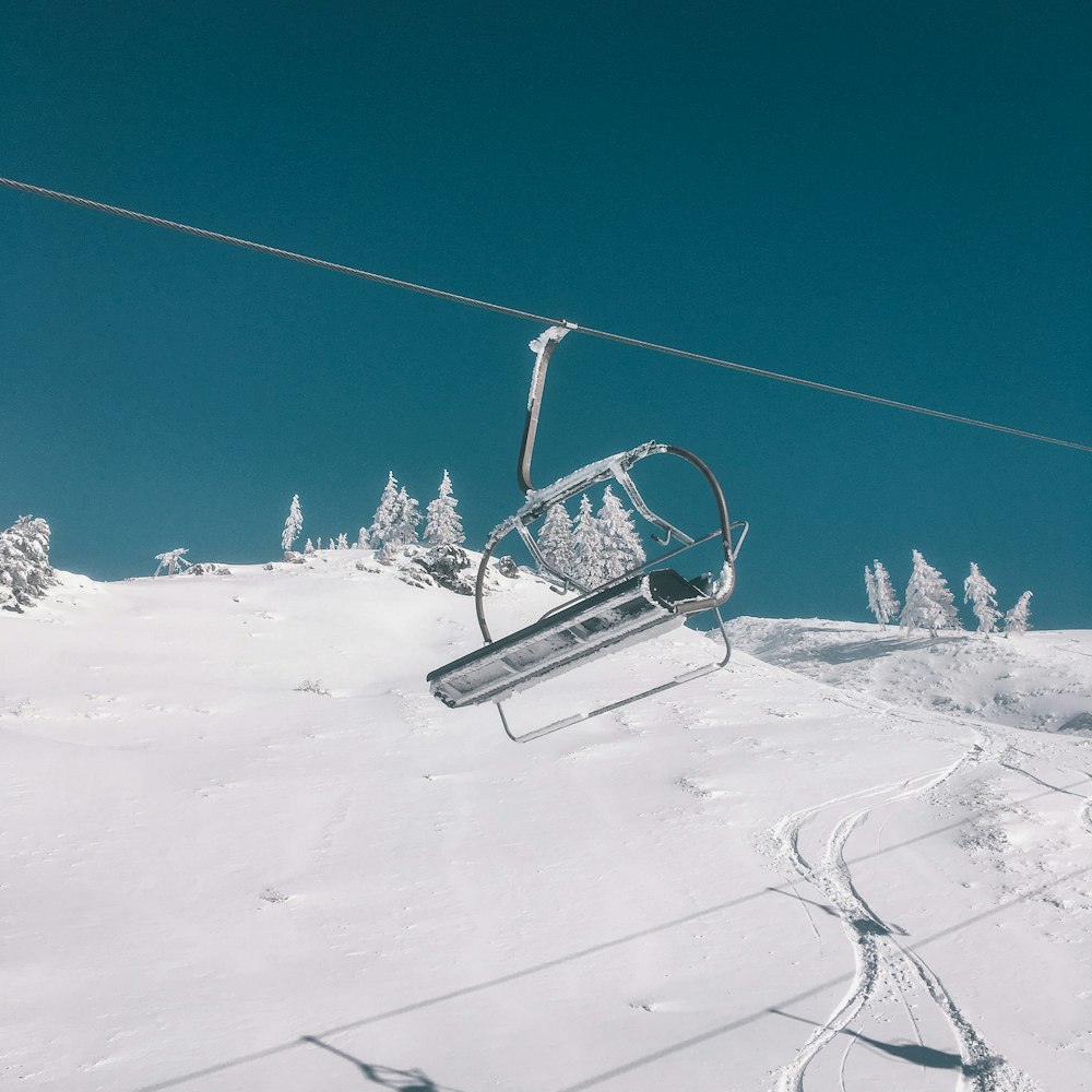 black cable car over snow covered ground during daytime