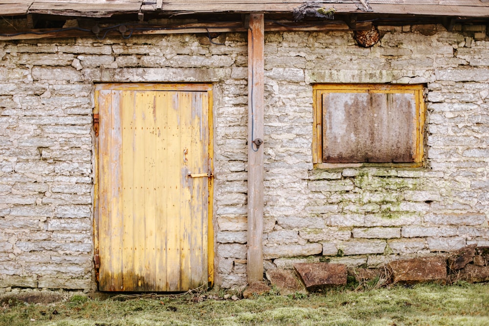 brown wooden door on gray brick wall