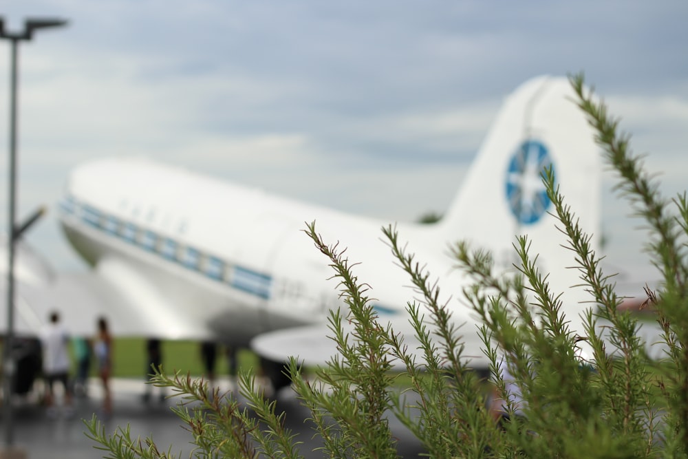 white airplane under white clouds during daytime