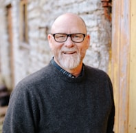 man in black crew neck sweater wearing black framed eyeglasses