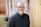 man in black crew neck sweater wearing black framed eyeglasses