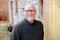 man in black crew neck sweater wearing black framed eyeglasses