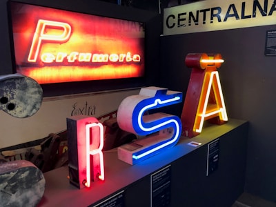 Variety of illuminated signs displayed in a showroom setting.