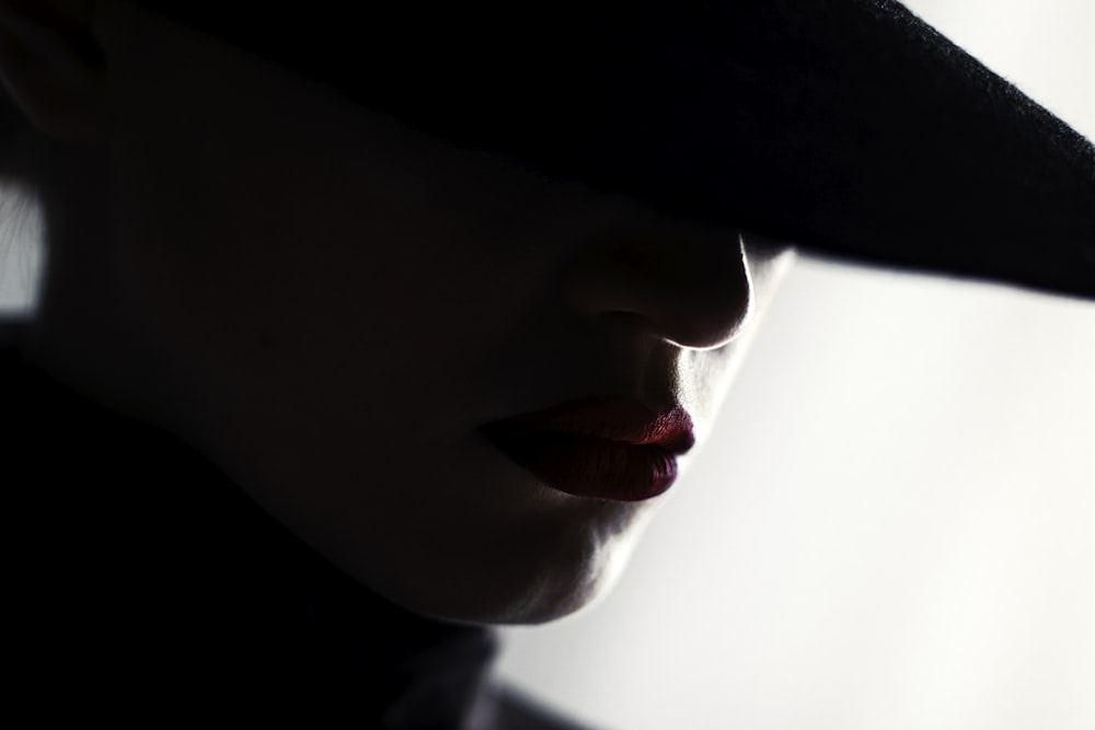 woman in black hat looking at the camera