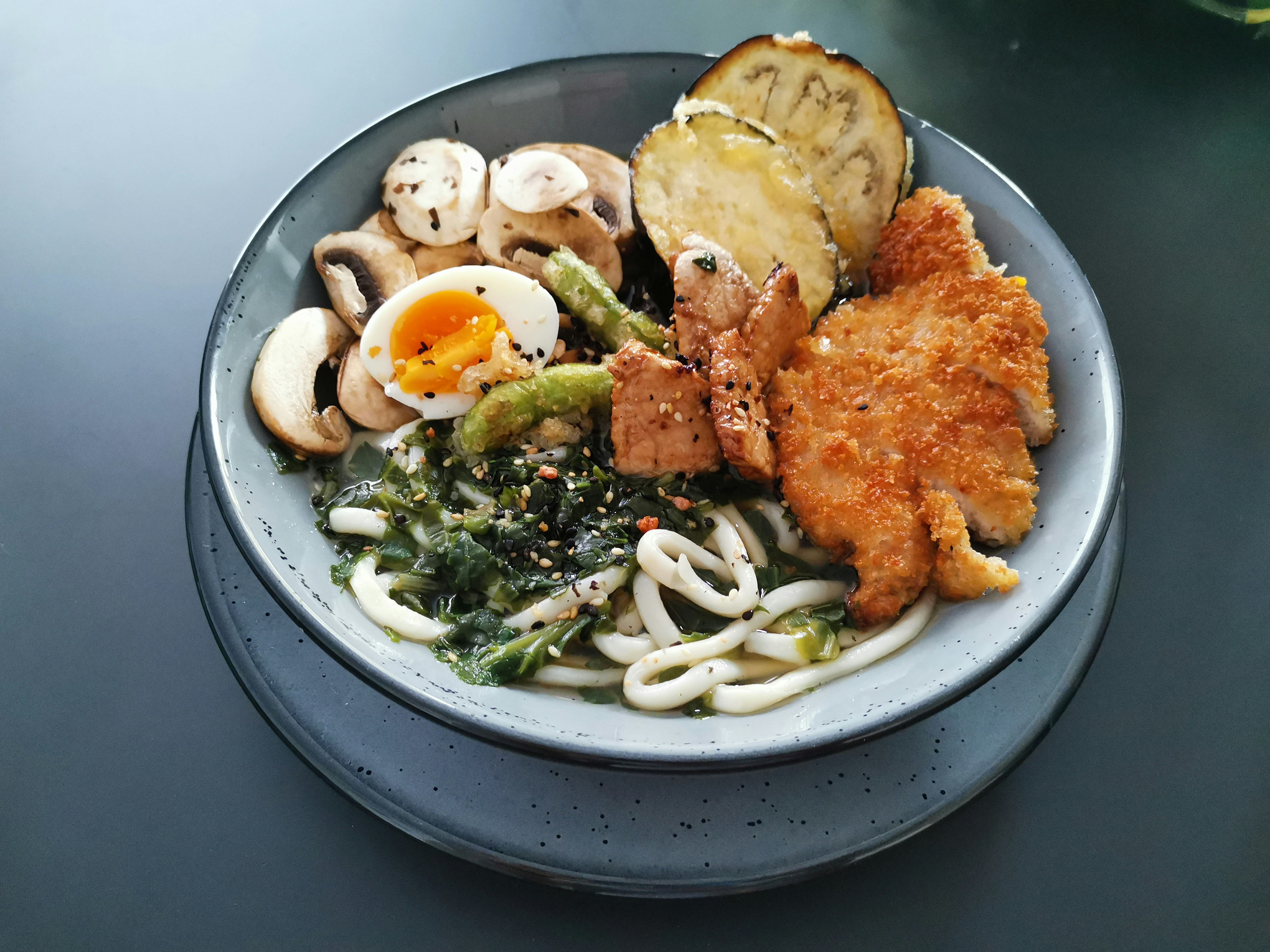 Udon with crumbed katsu, egg and mushrooms