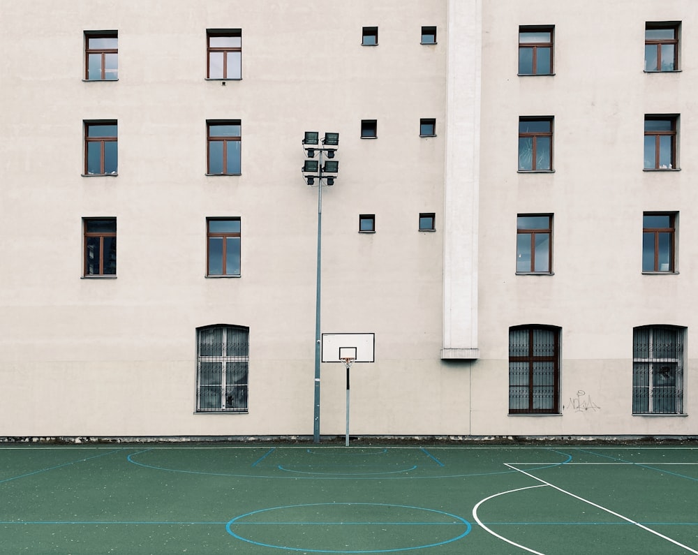 basketball court in front of white concrete building