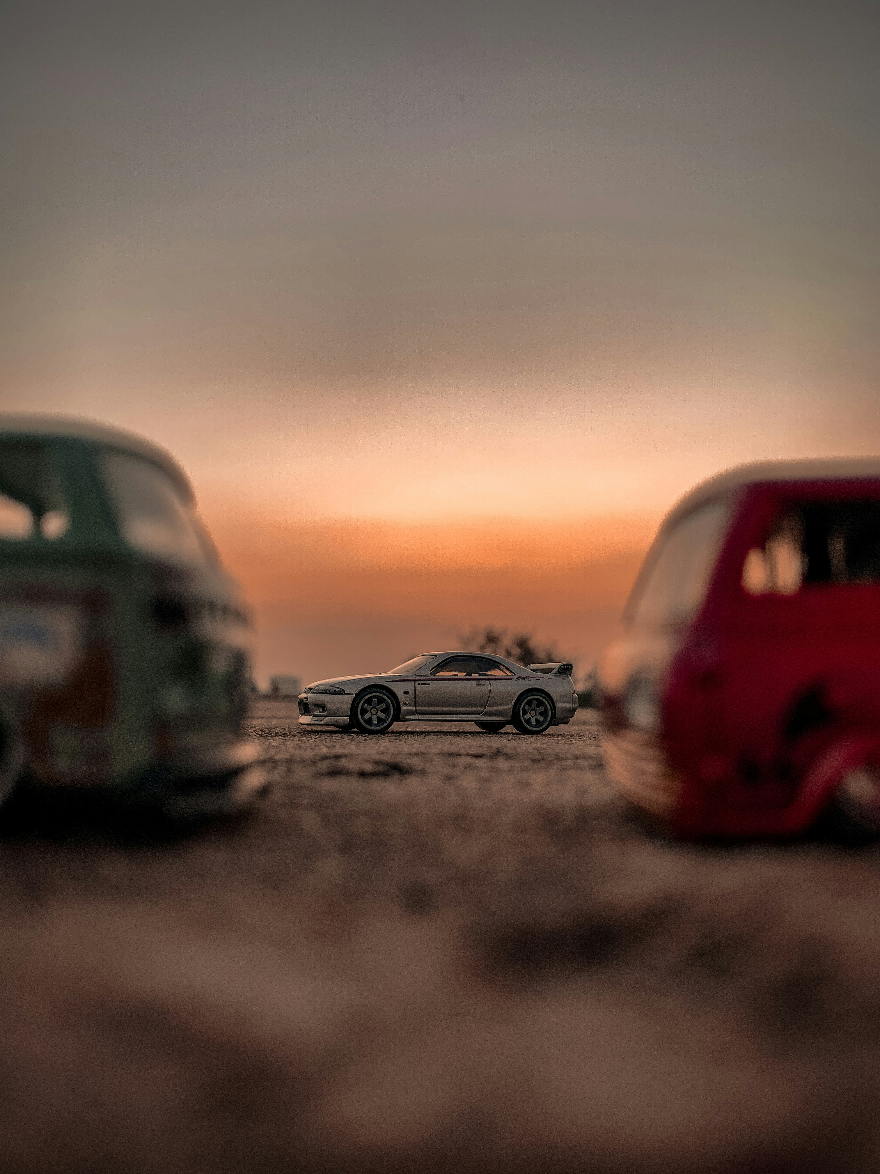 red and black volkswagen beetle on road during sunset