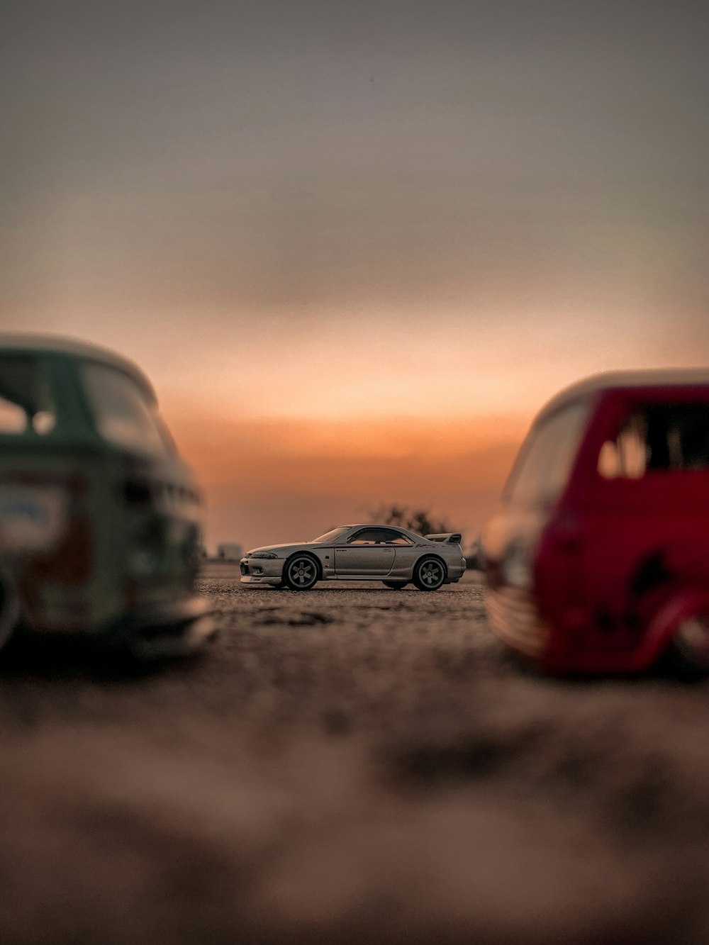 red and black volkswagen beetle on road during sunset