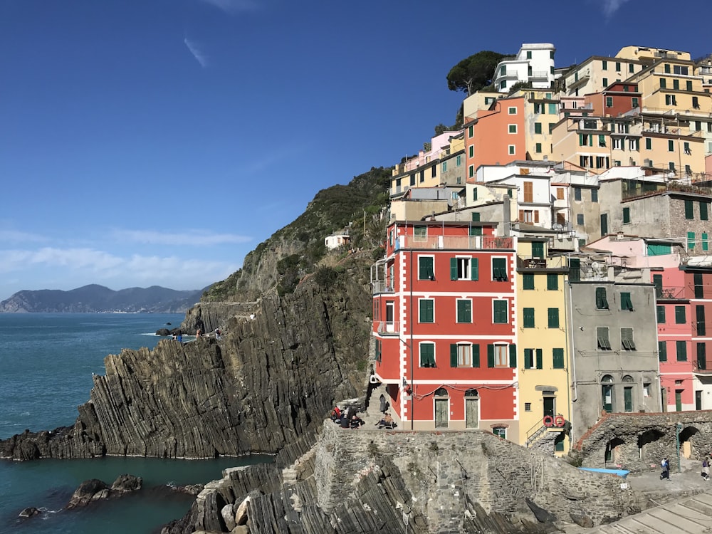 red yellow and white concrete buildings near body of water during daytime