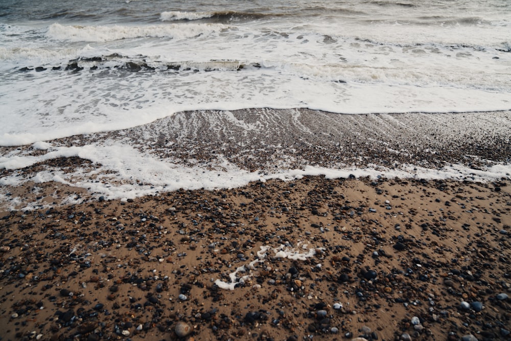 ocean waves crashing on shore during daytime