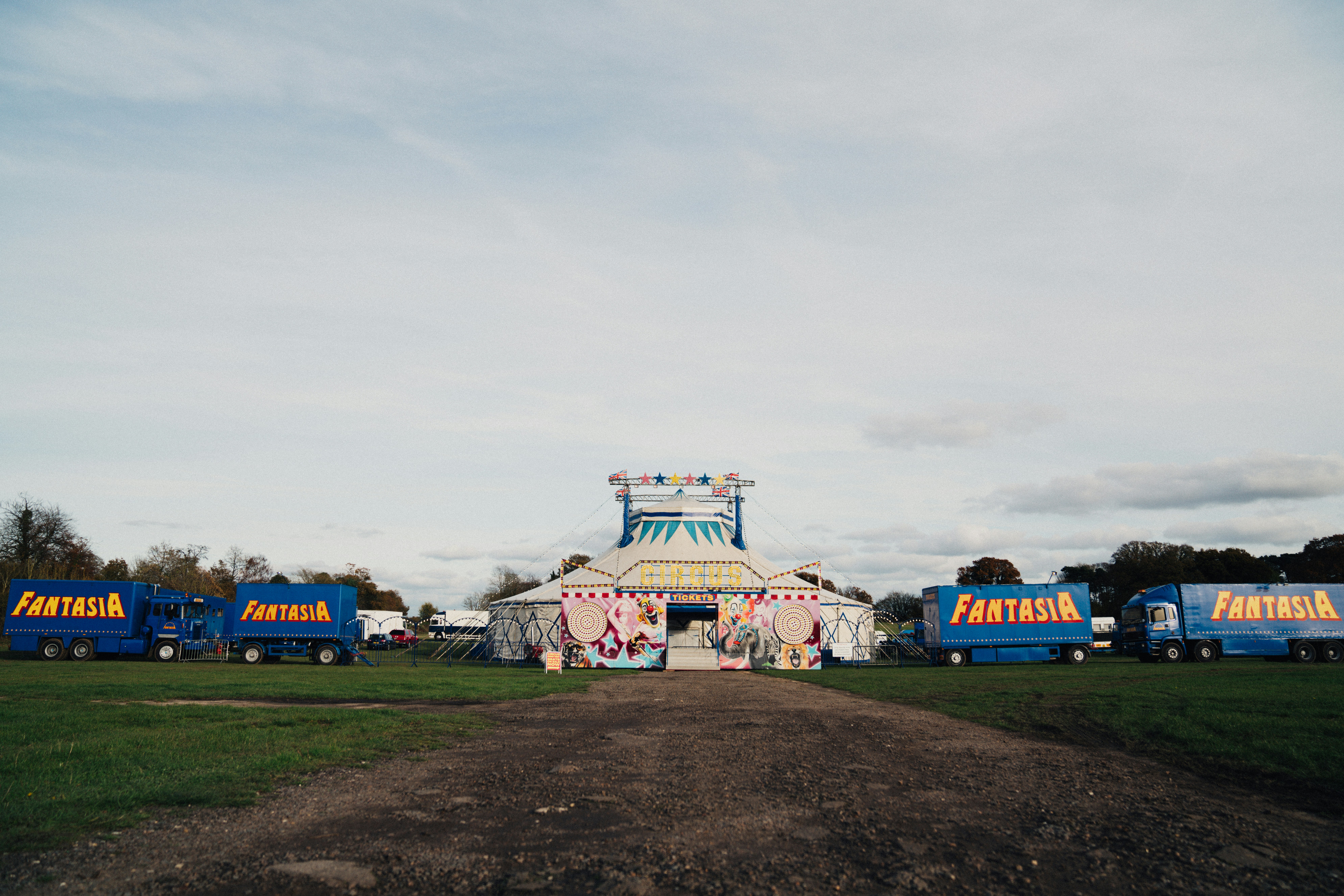 assorted color tent on green grass field under white clouds during daytime