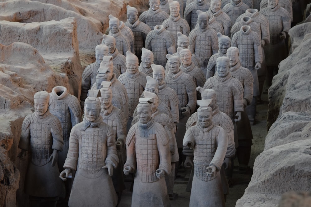 brown stone statues on brown rock formation during daytime