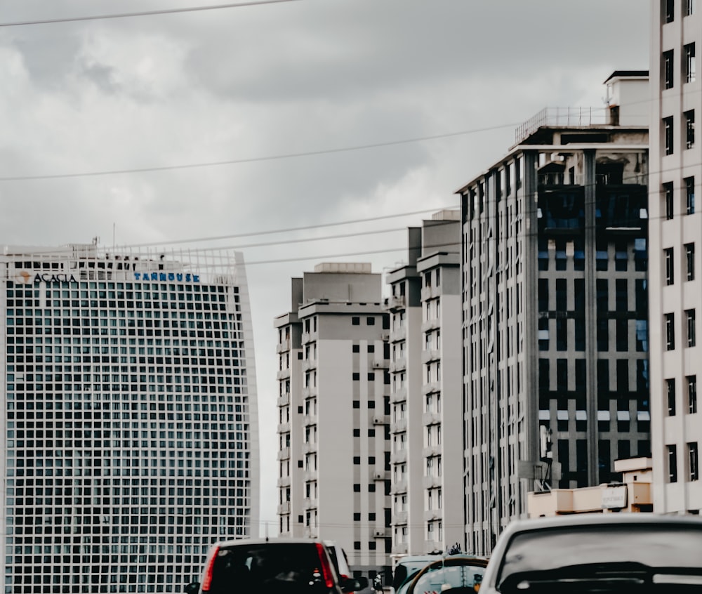 white car on road near high rise buildings during daytime