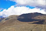 A sweeping mountain landscape in Kurdistan under a bright blue sky.