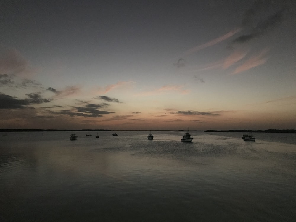 silhouette of people on beach during sunset